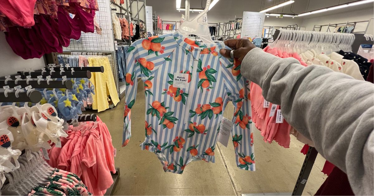 person holding oranges girls swimsuit in old navy store