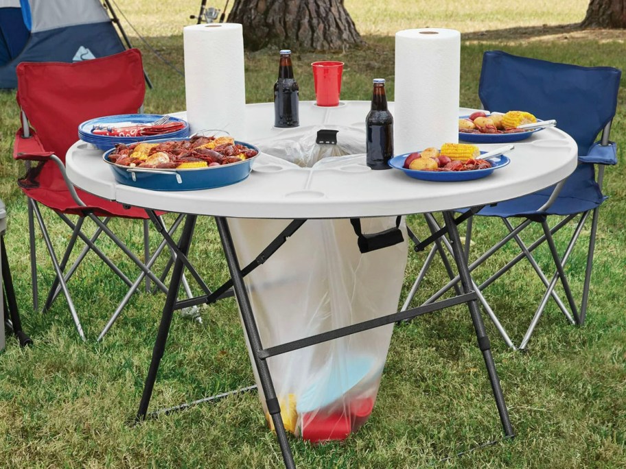 white camping table with reda nd blue chair next to it