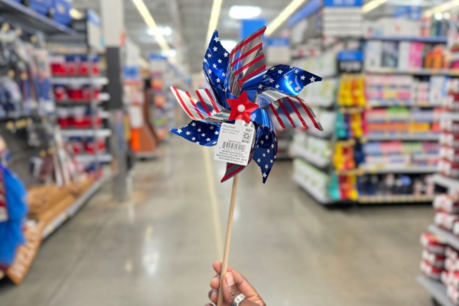 womans hand holding a pinwheel