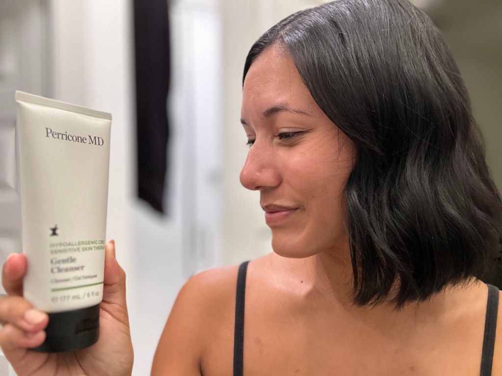 woman looking at skin cleanser