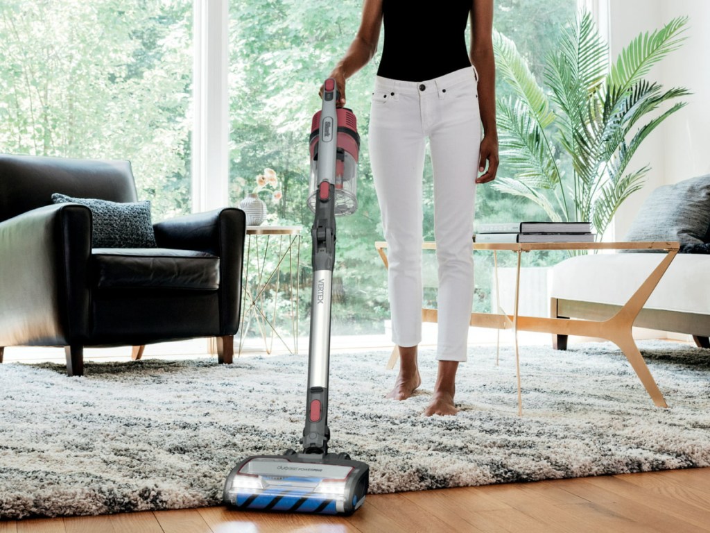 person using Shark Vertex Cordless Stick Vacuum Cleaner with DuoClean PowerFins on the rug