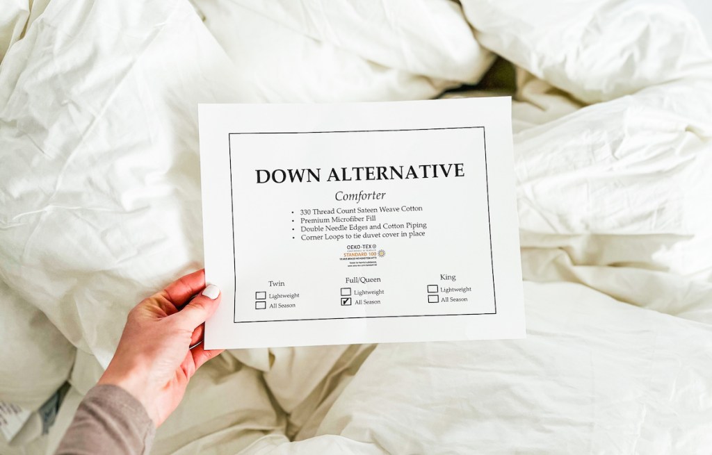 hand holding a down alternative comforter sign over boll and branch bedding alternative