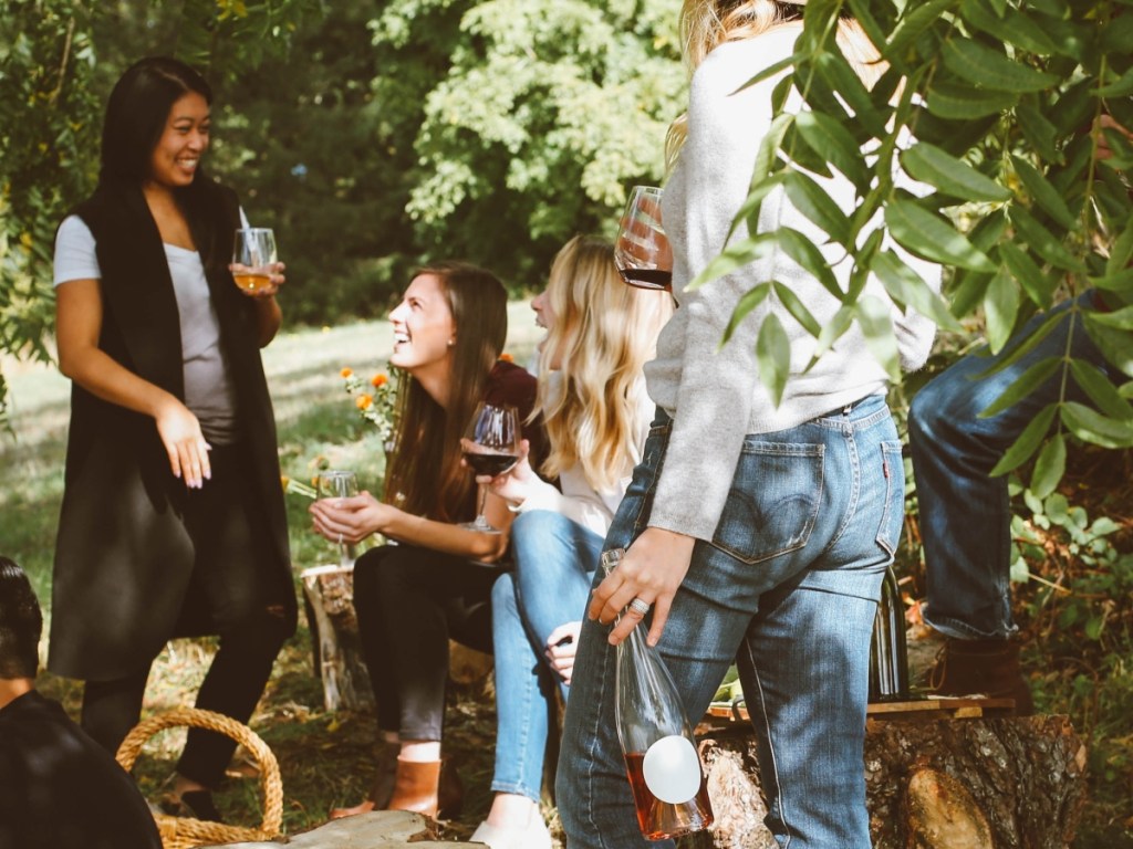 women drinking wine at a party outdoors