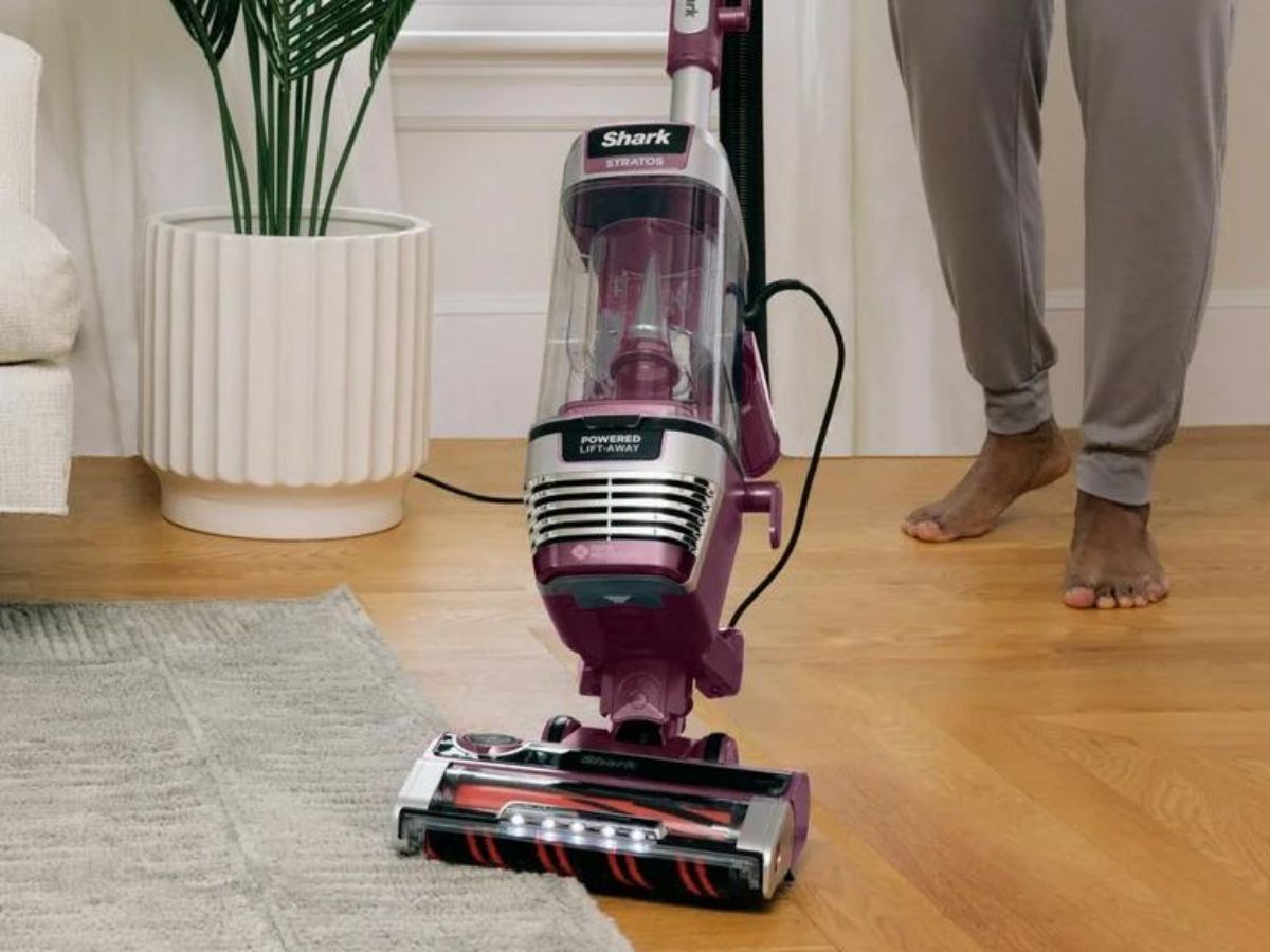 person using shark vacuum 