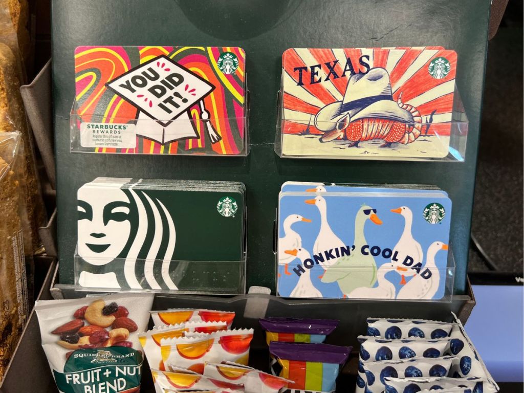 various Starbucks gift cards on display in store