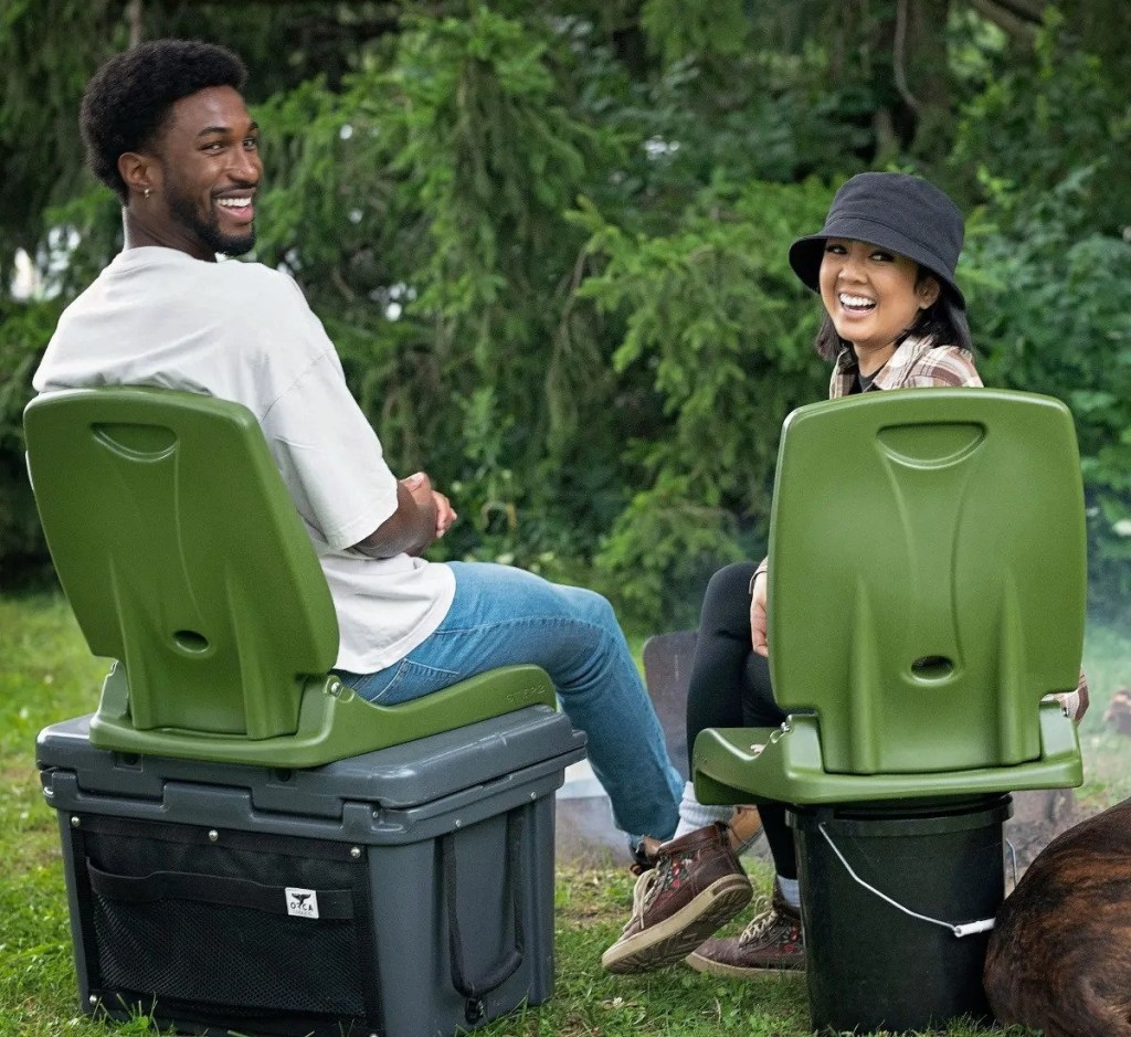 two people sitting on olive green flip seats