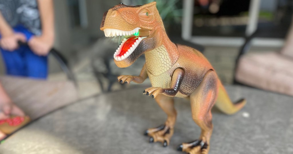 T Rex toy sitting on table on patio