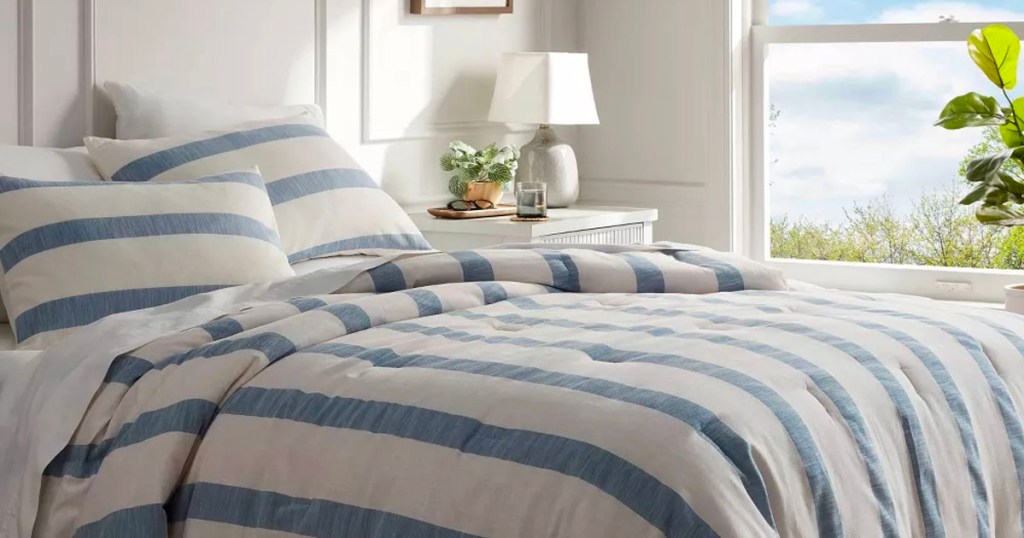 blue and white striped comforter set on bed
