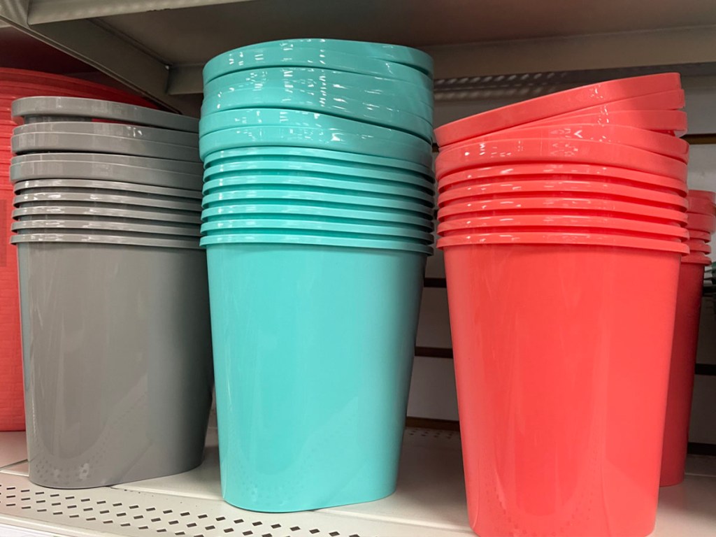 gray, teal and orange small trash cans on shelf in Dollar Tree