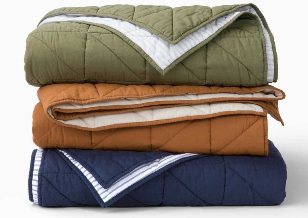 navy green and cinnamon quilts stacked