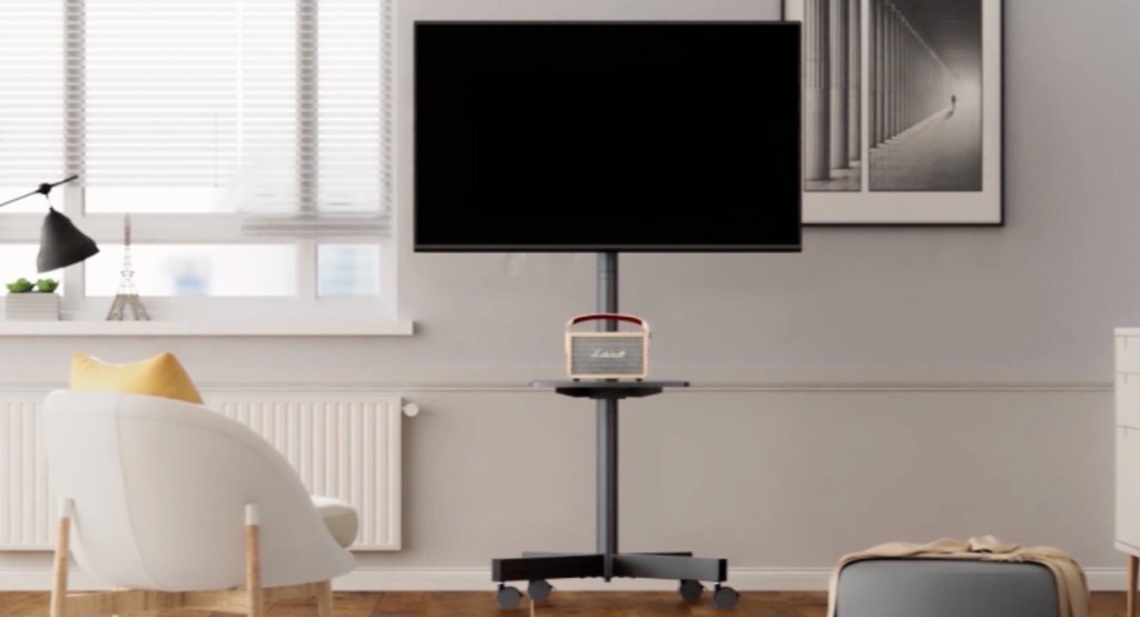 tv on the stand displayed in living room with other items around