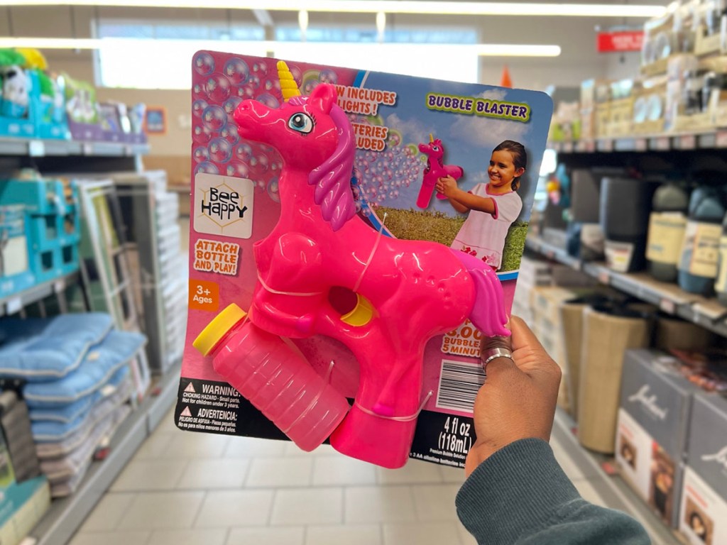 hand holding pink unicorn bubble blower