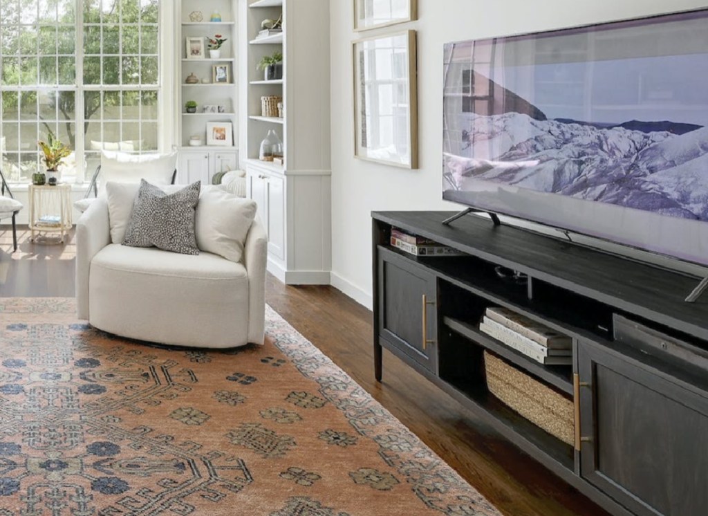 walmart tv stand displayed in loving room with couches, tv and rugs