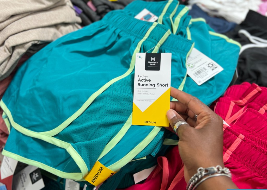 woman hold members marks shorts at the store