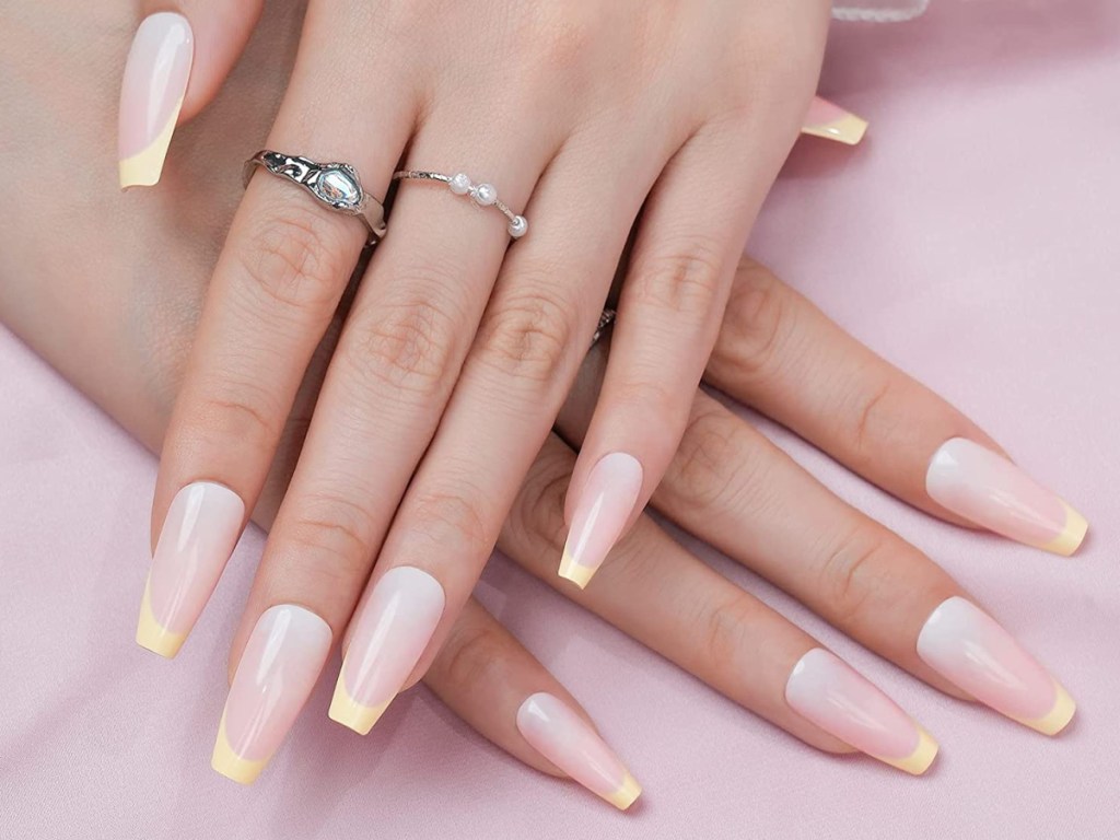 woman wearing Jofay Fashion Press-on Nails 24-Count Kit in French Pink Yellow 