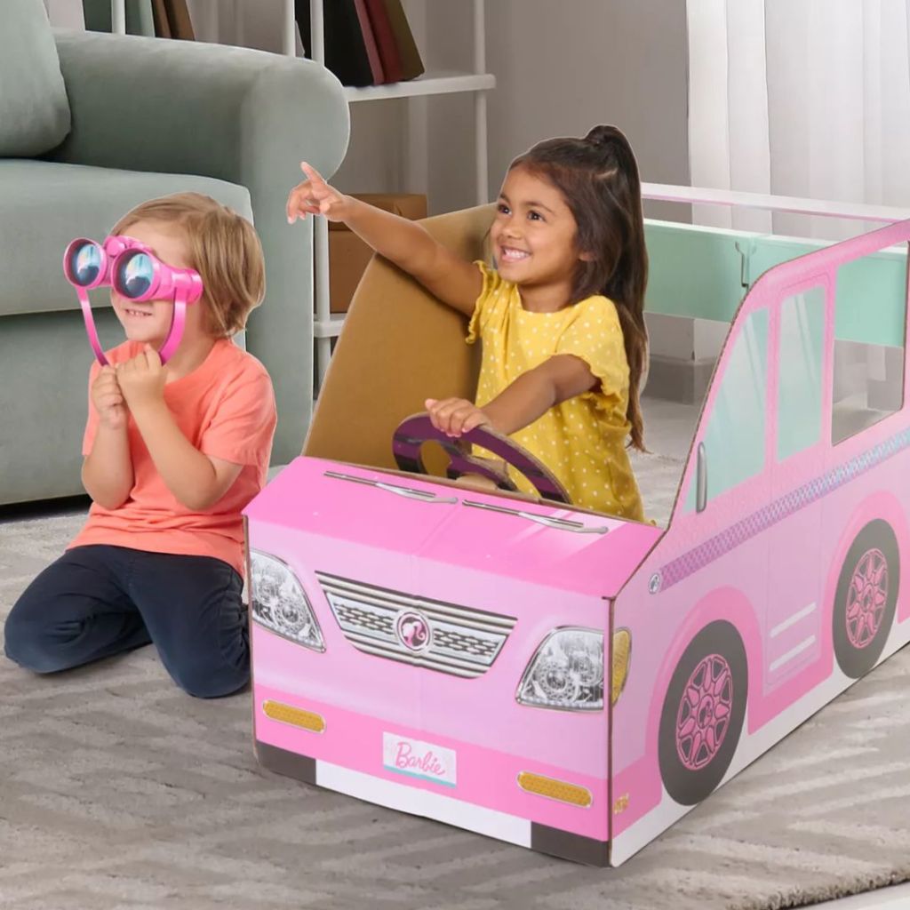Two little girls playing in a Pop2Play Barbie Camper