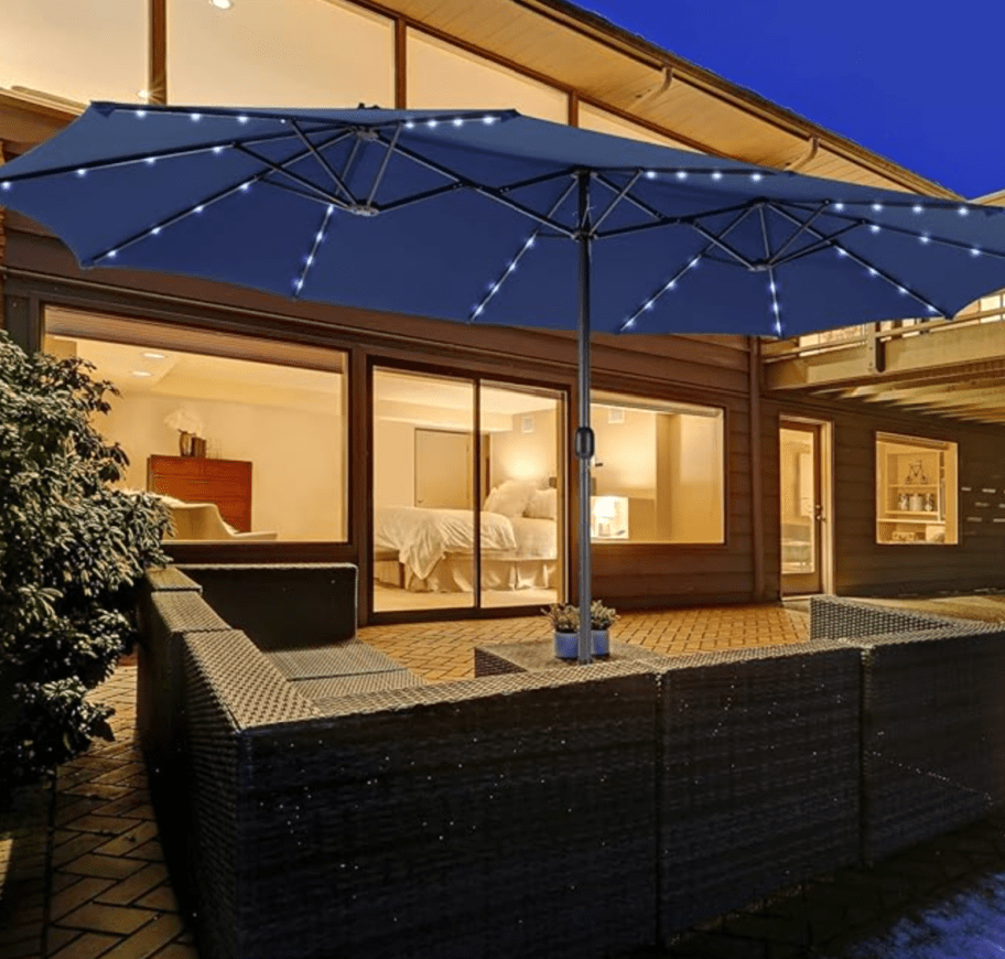 A 15ft blue patio umbrella with lights and a base