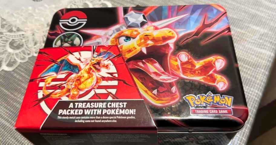 Pokemon metal tin with Charizard on the cover, packaging on the corner