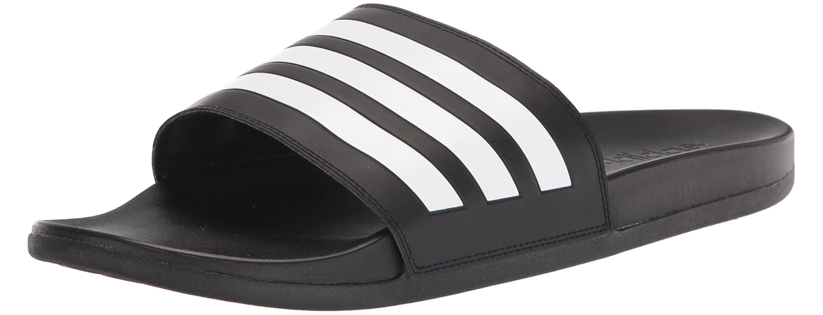 black adidas slides with white stripes