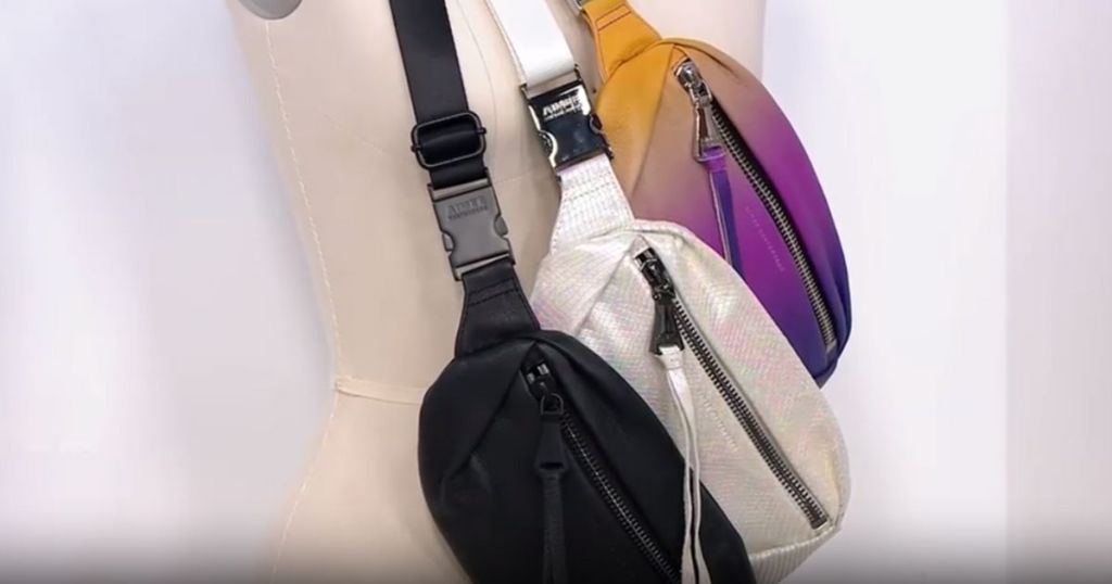 ombre belt bag, white belt bag, and black belt bag hanging on mannequin