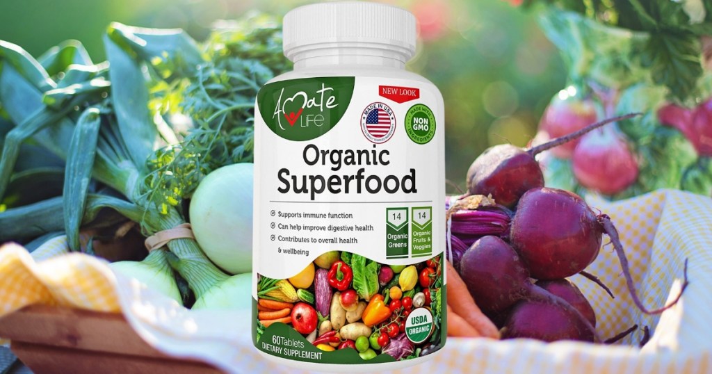Bottle of Amate Life Supergreens with vegetables behind it