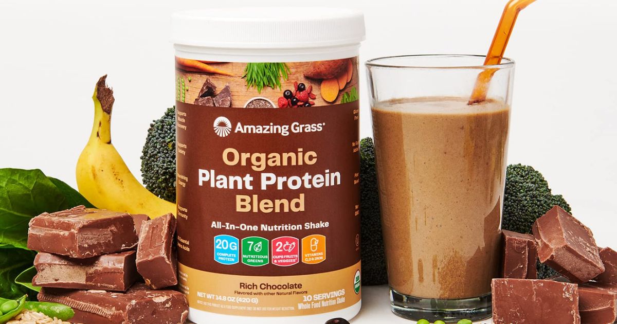 A can of chocolate protein powder surrounded by fruits and veggies
