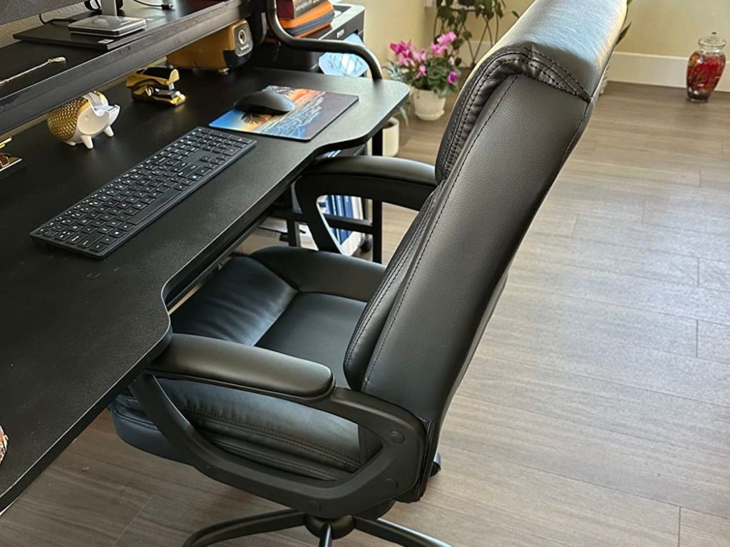 black office chair pushed under desk