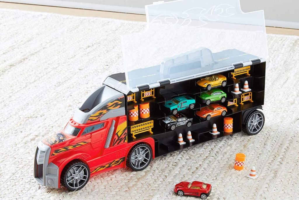 Amazon Basics Toy Truck Hauler Carrier and Accessories sitting on a carpeted floor