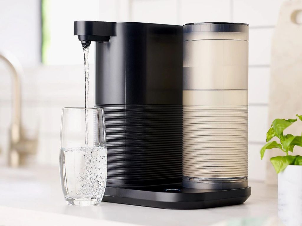 Water filter dispensing water into a glass
