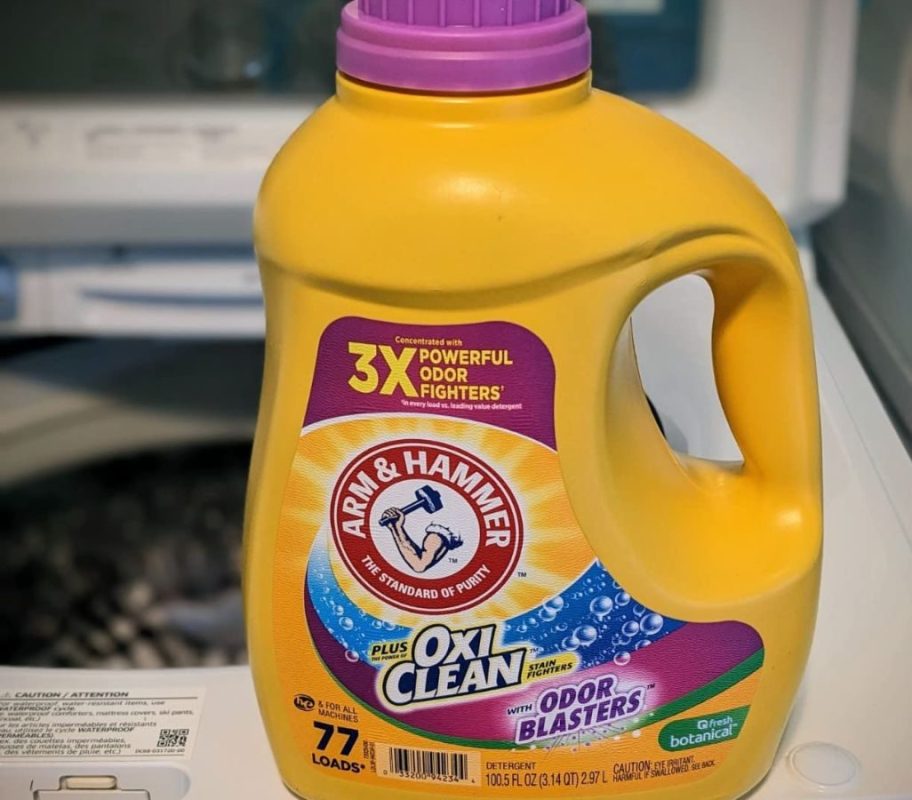 A bottle of Arm & Hammer Laundry Detergent on a washing machine