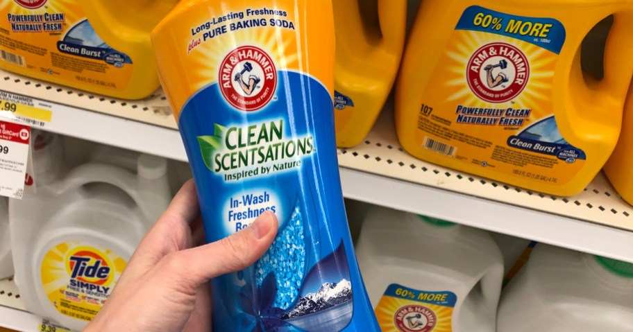 hand holding a container of Arm & Hammer In-Wash Scent Booster