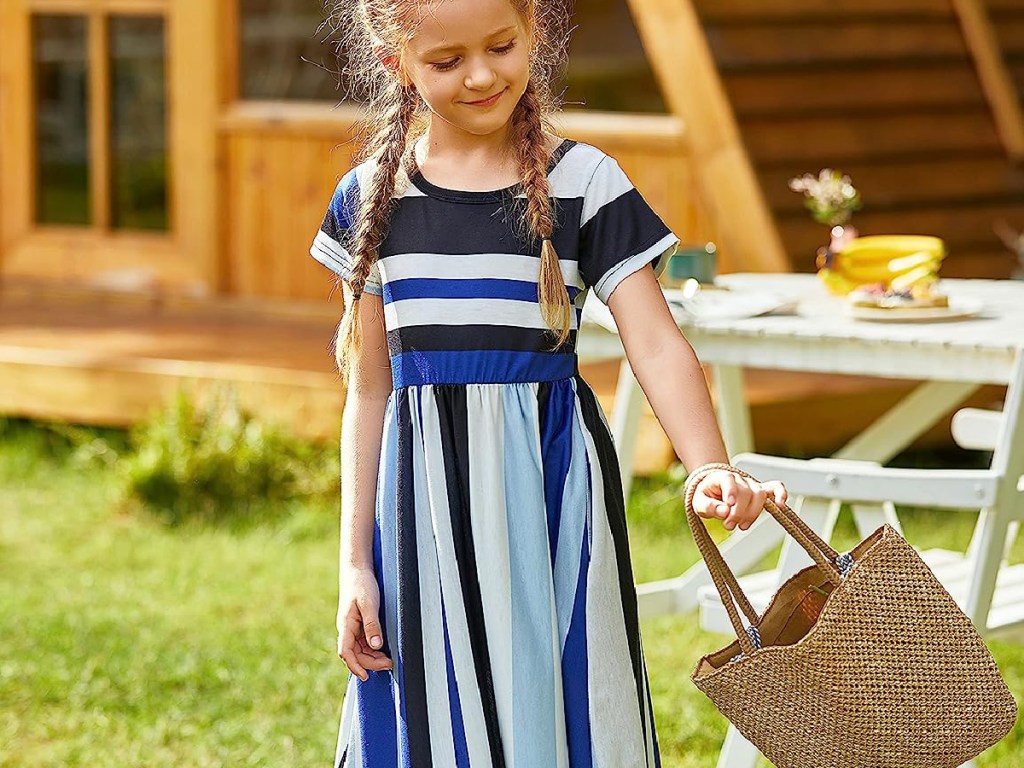 girl wearing a blue striped Arshiner Girls Maxi Dress and holding a basket