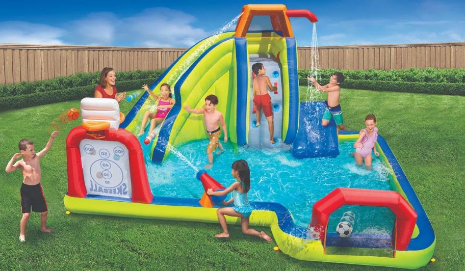 kids playing on an inflatable backyard water park