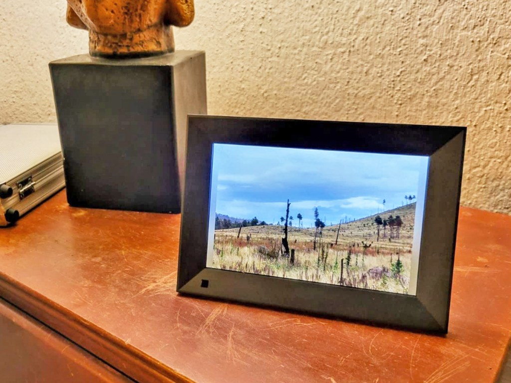 black digital photo frame on a wood table