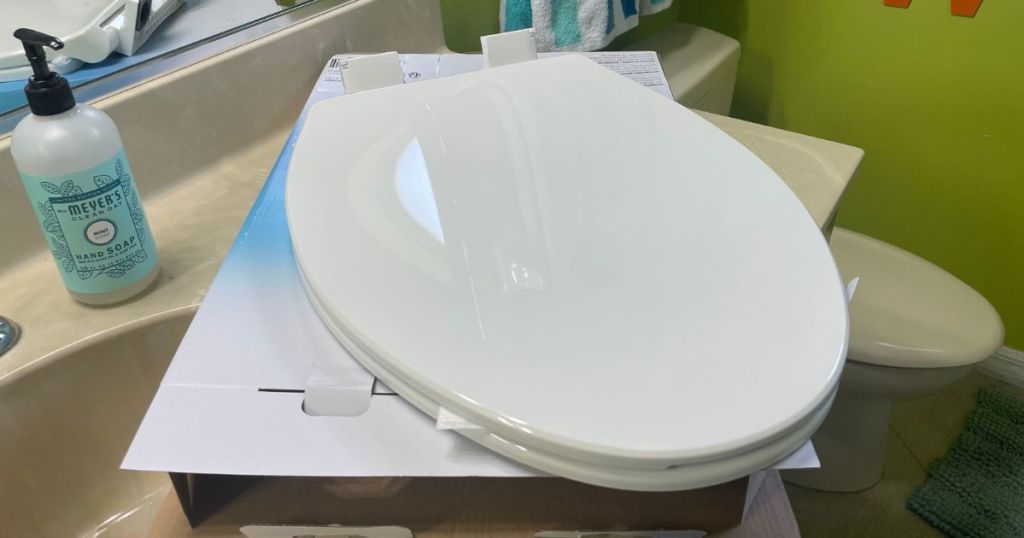 toilet seat with toddler seat attached out of package on bathroom counter