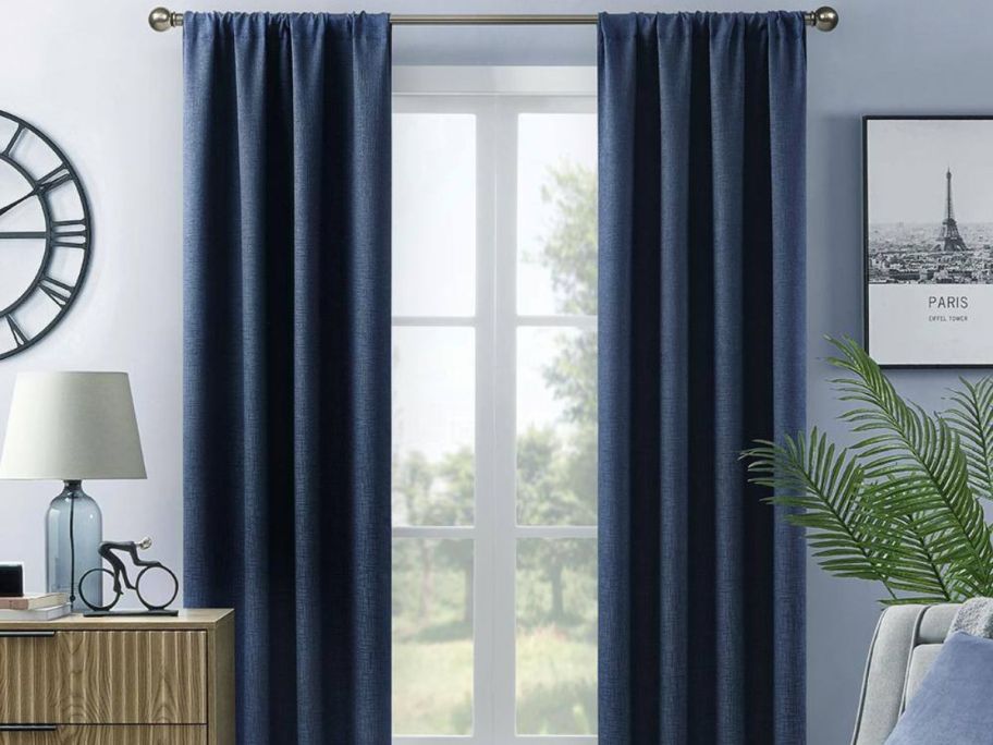 A window with Lightsout Hayden Embossed 38" x 84" Rod Pocket Blackout Curtain Panels