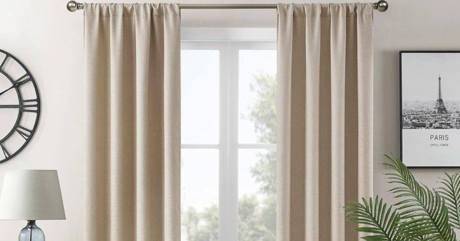 A window with Lightsout Hayden Embossed 38" x 84" Rod Pocket Blackout Curtains