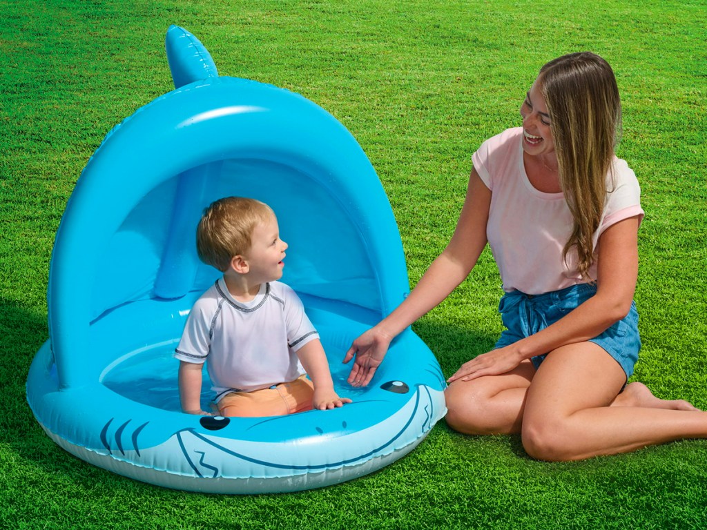 child using the Blue Shark Shade Inflatable Baby Pool