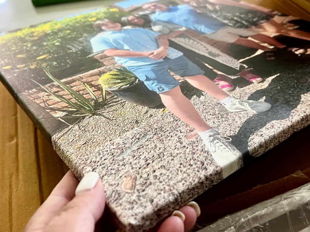 person unboxing canvas print from canvas champ