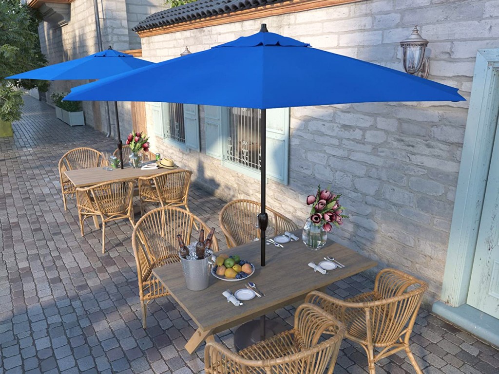 blue patio umbrellas over tables and chairs