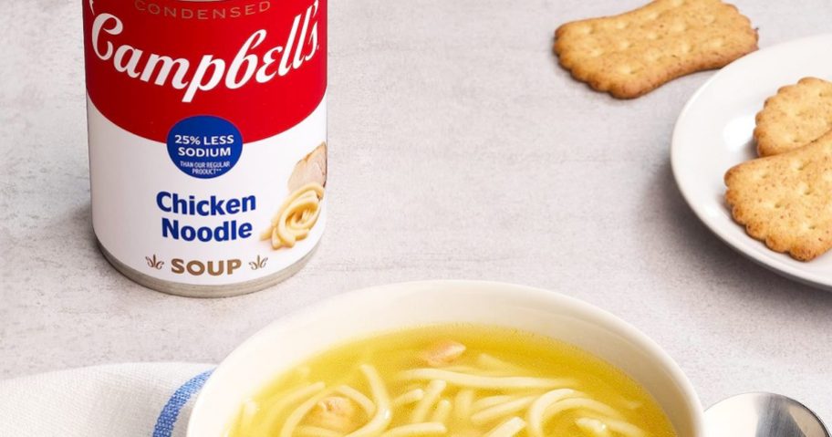can of Campbell's Less Sodium Chicken Noodle Soup next to bowl of soup