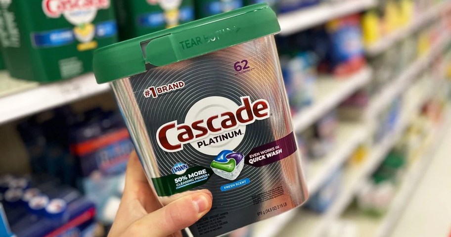 hand holding up a container of cascade dishwasher pods