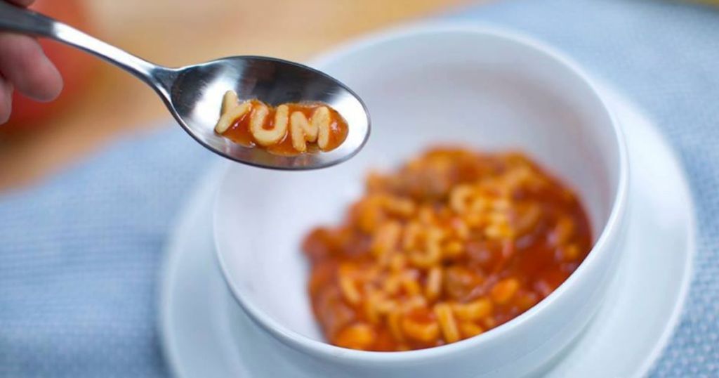 Bowl of Chef Boyardee ABCs and 123s with a spoon with pasta spelling YUM