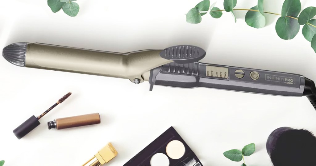 black and gold curling iron near makeup products