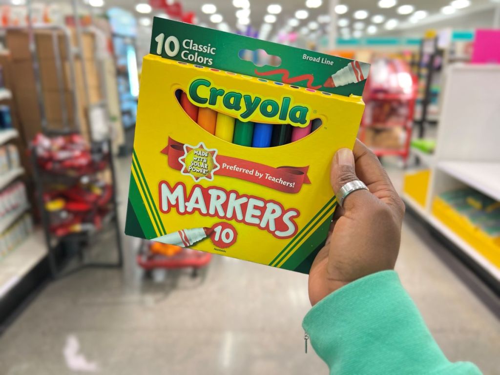 Hand holding a pack of Crayola Broad Line Markers