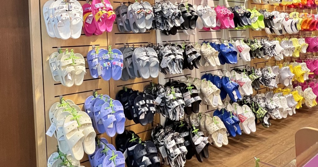 display wall of crocs sandals and clogs in store