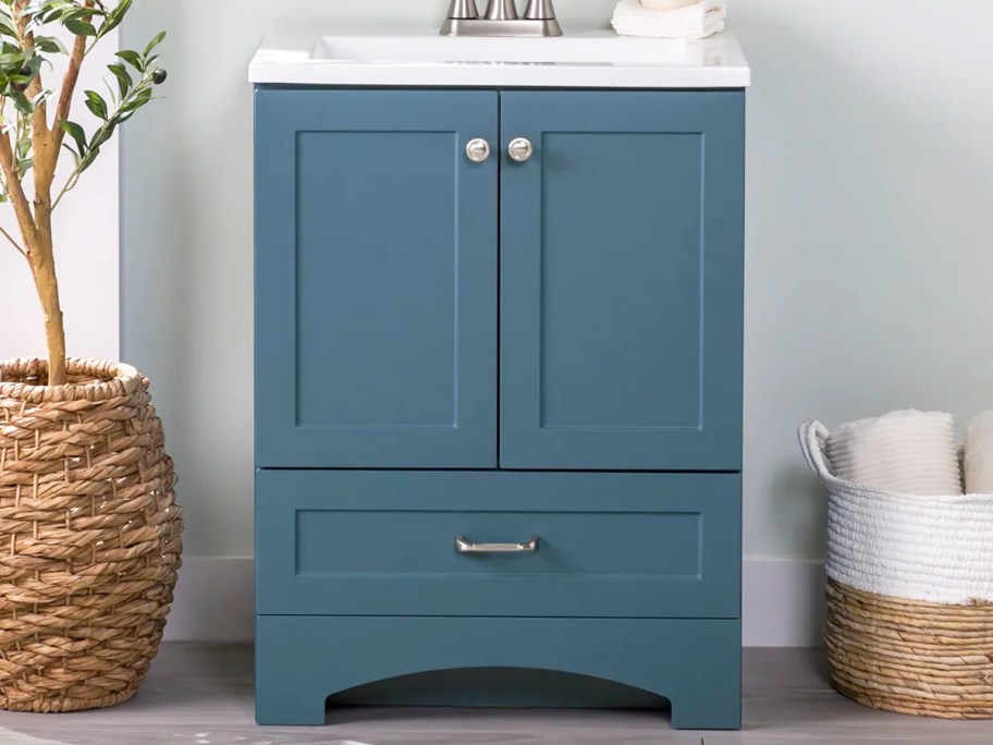 blue bathroom vanity with a white top