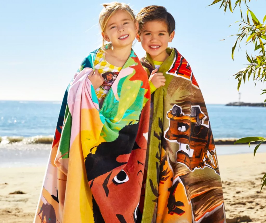 two kids wrapped in disney beach towels