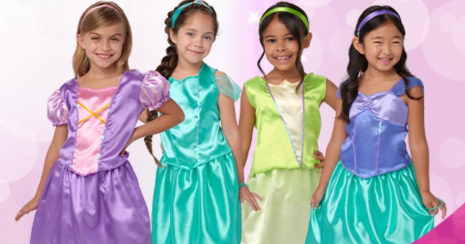 girls wearing costumes from the disney princess dress up trunk