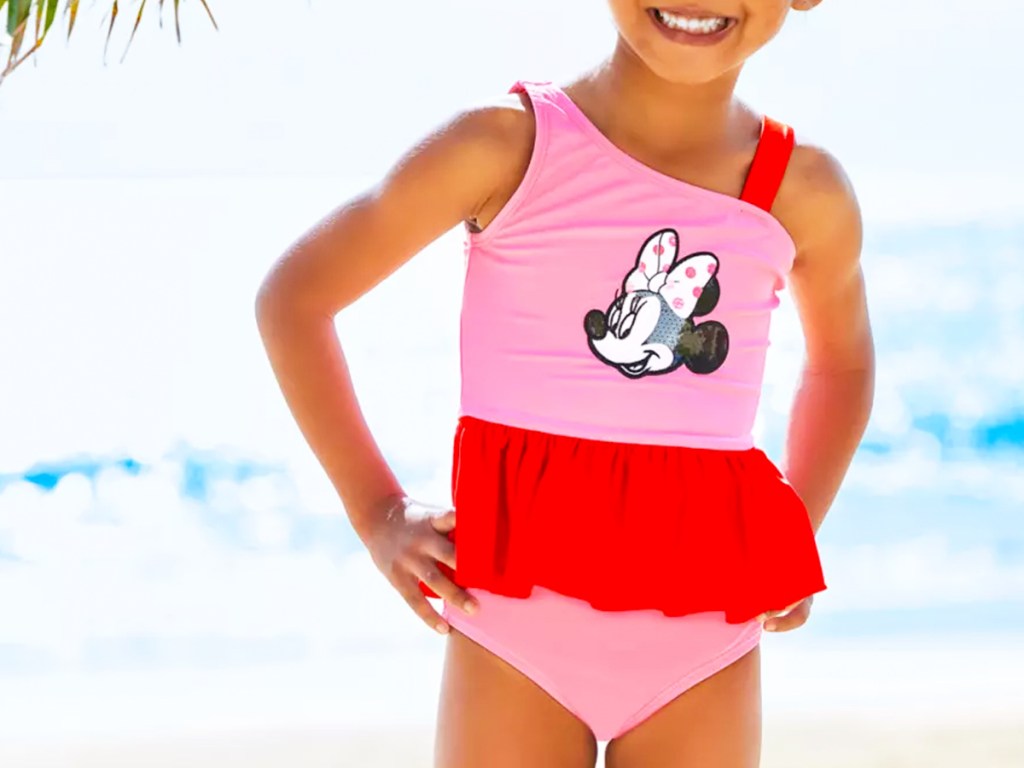 girl in a pink and red minnie mouse bathing suit